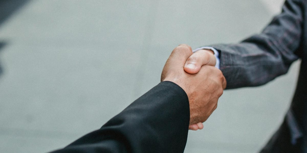 Two business professionals shaking hands, symbolizing a successful agreement or partnership.