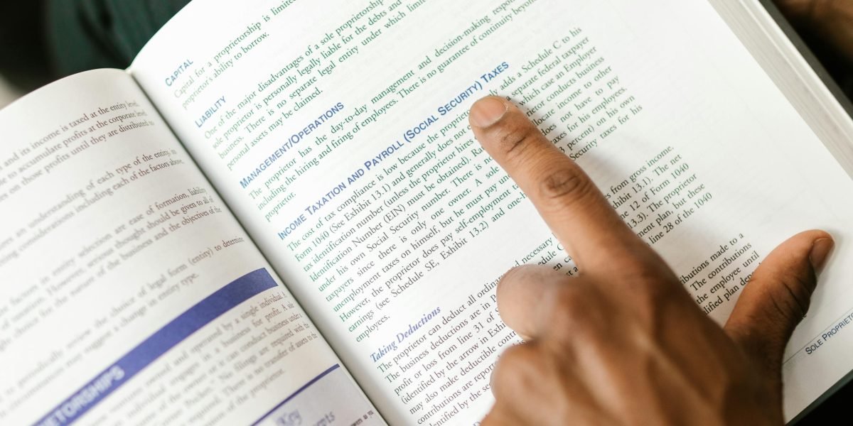 A person intently reading a thick textbook, symbolizing the importance of a reliable guide in a complex field.