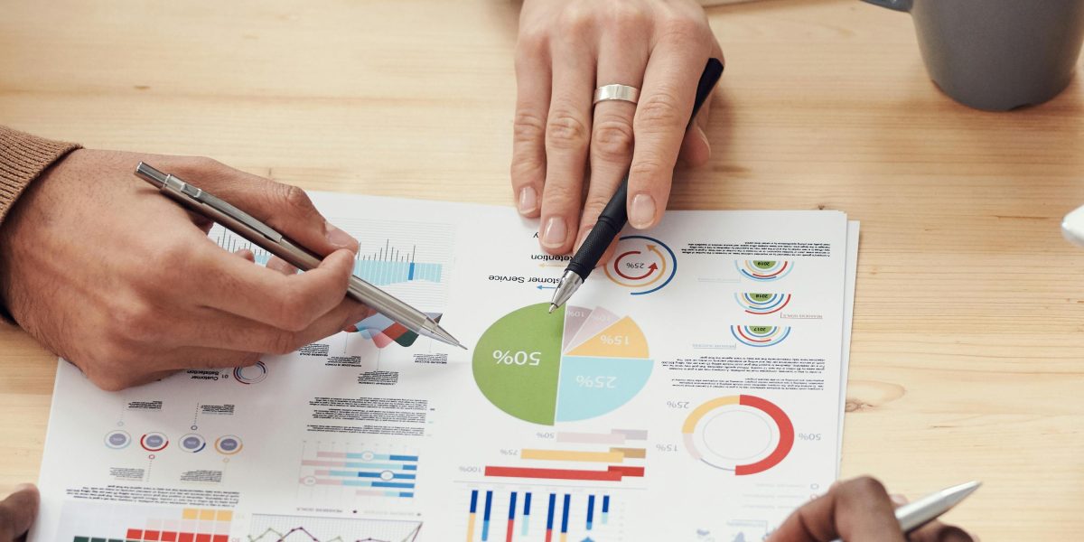 A diverse team of professionals actively collaborating around a visual display, analyzing complex data to derive insights.