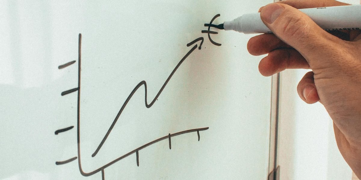 A person drawing a roadmap or flowchart on a whiteboard, illustrating the strategic planning involved in selecting an AI platform.