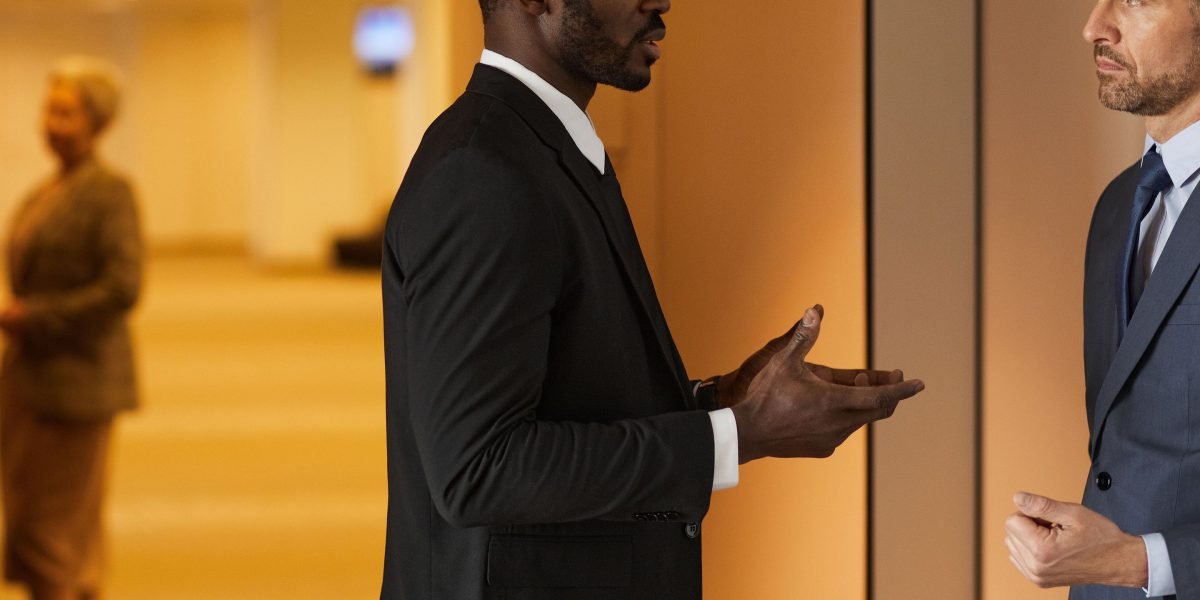 Professionals networking at an event, exchanging information and building connections for career growth.