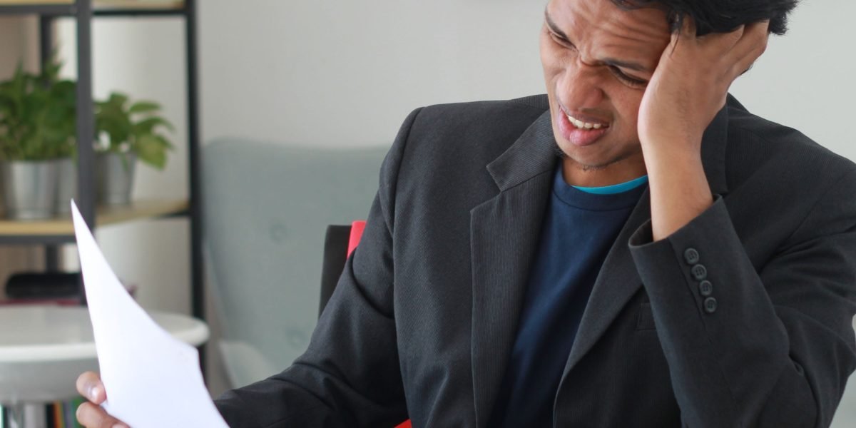 A person feeling overwhelmed by a deluge of digital information, symbolizing the challenge AI productivity tools aim to solve.