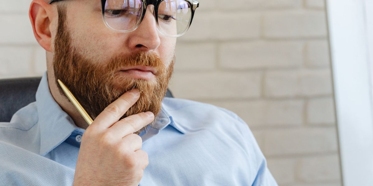 A person thoughtfully analyzing complex information, symbolizing the process of turning raw data into actionable insights.