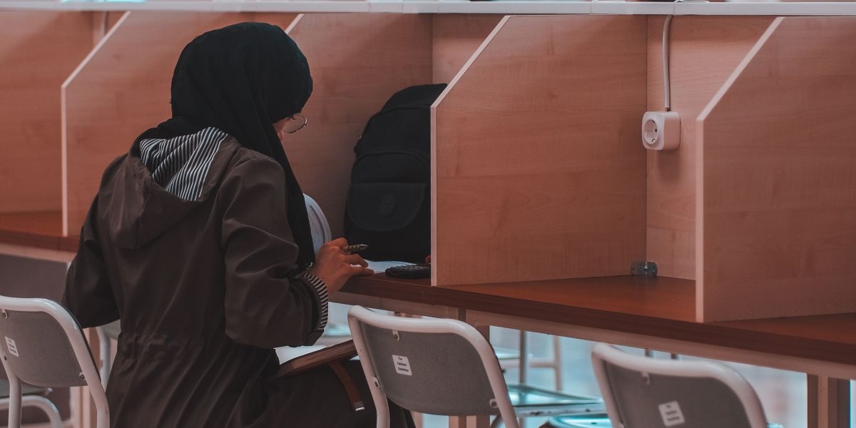 An individual engaged in focused, structured learning at a desk.