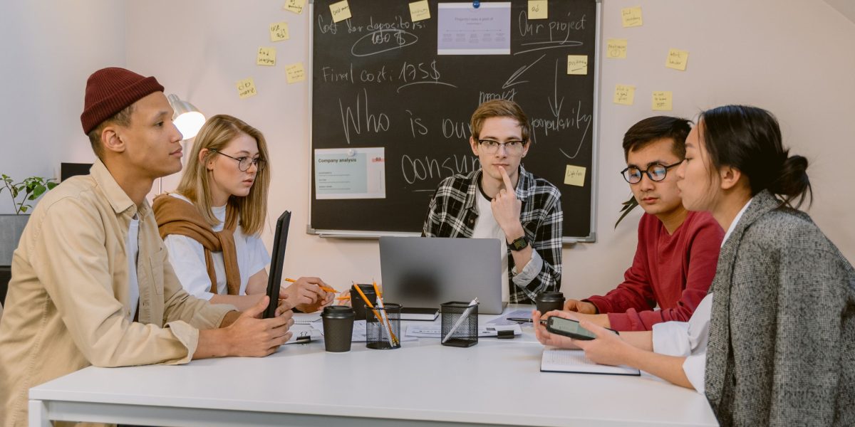 A professional engaging in continuous learning and knowledge sharing within a team setting.