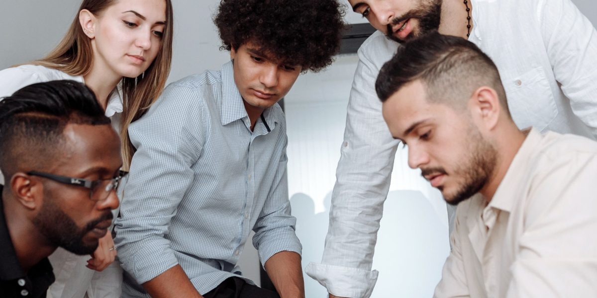 A diverse team collaborates on a strategic problem, reflecting the complex nature of AI policy.