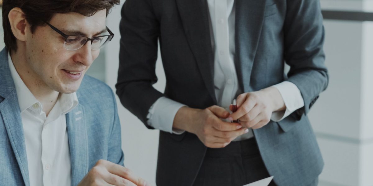Professionals carefully reviewing documents, symbolizing the effort to understand complex AI policy frameworks.