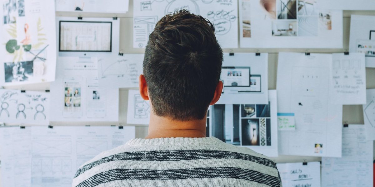 A professional engaging with data or a project on a whiteboard, representing practical application of AI concepts.