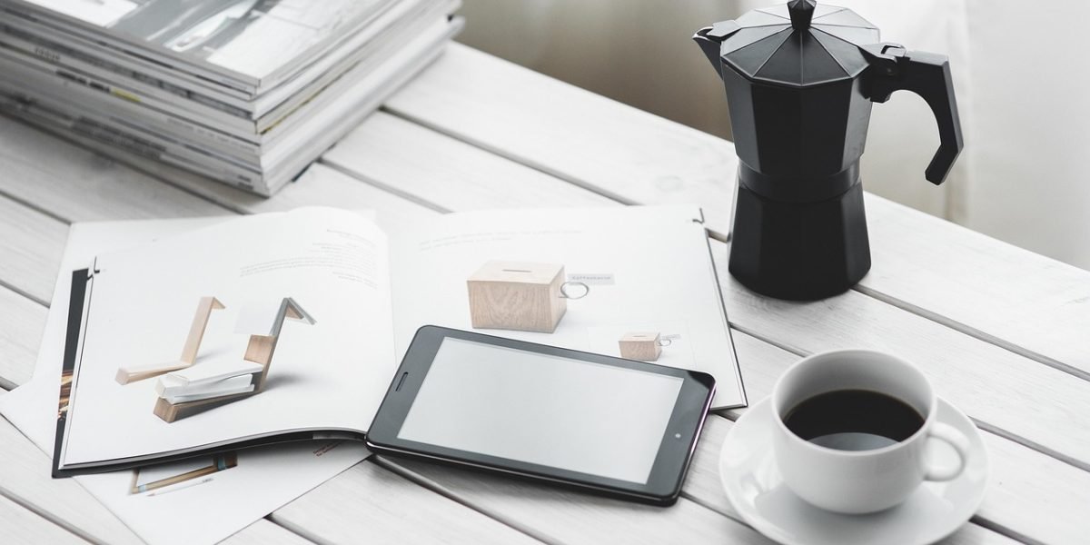 A professional utilizing short, focused learning sessions on a tablet in a coffee shop setting.