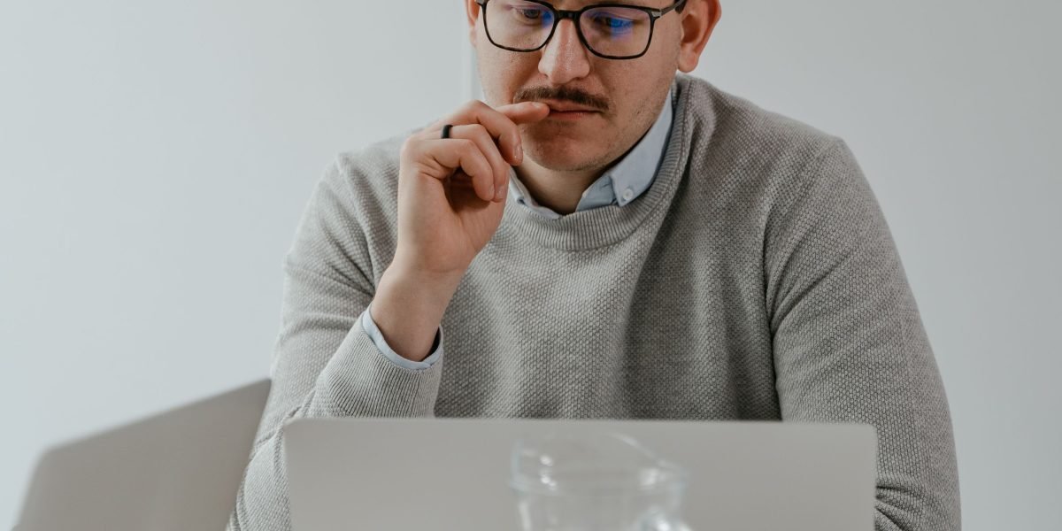 A person intently focuses on complex information, aiming to find clear insights amidst overwhelming data.