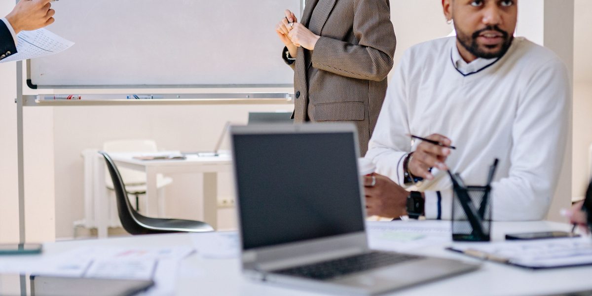 A diverse team collaboratively reviews data and strategic plans, indicating confident decision-making.