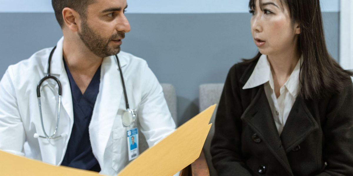 A doctor shares information with a patient, enabled by data insights that lead to better healthcare decisions.