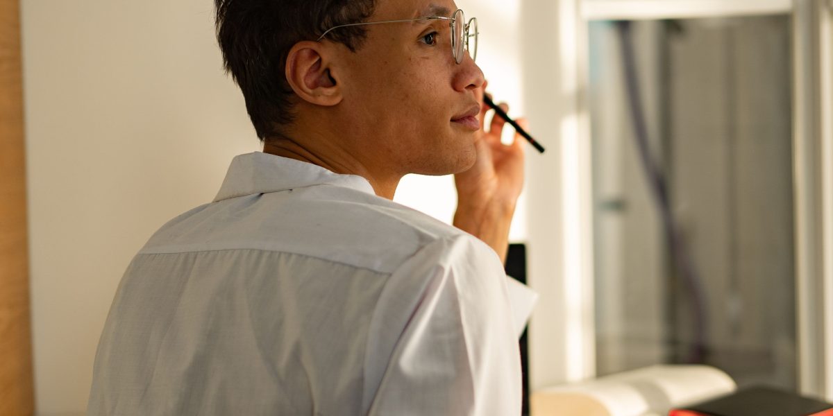 A professional looking thoughtful, navigating complex information to find clarity and practical solutions.