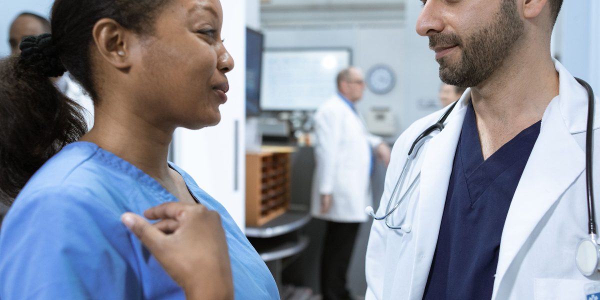 Medical professionals in a hospital setting, collaborating and discussing patient data and treatment plans.