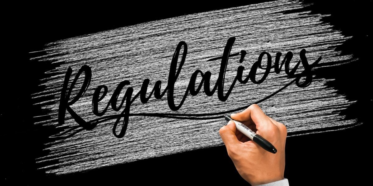 A group of professionals engaged in a thoughtful discussion, reflecting the ongoing debate and development of AI regulations and safety standards.