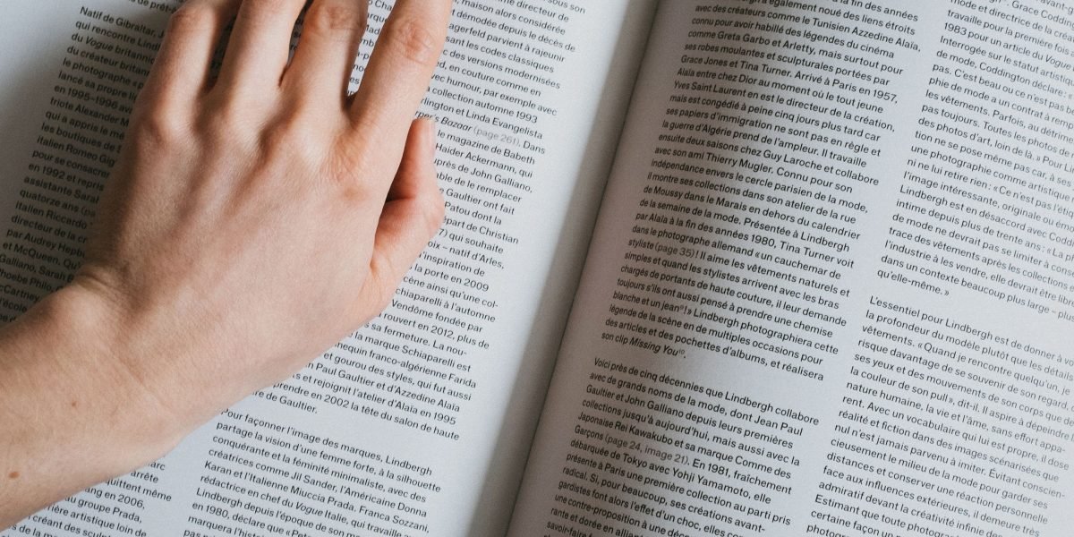 A professional engrossed in reading, illustrating the continuous learning required to stay updated with fast-evolving AI trends.