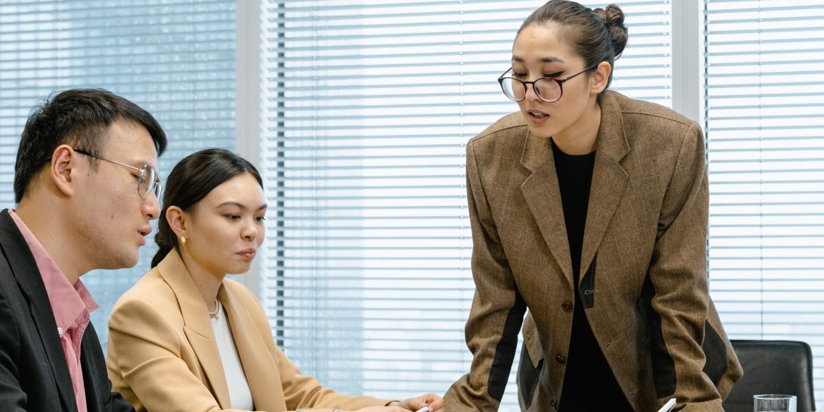 A team collaborates in a meeting room, thoughtfully considering ethical implications and making responsible decisions.