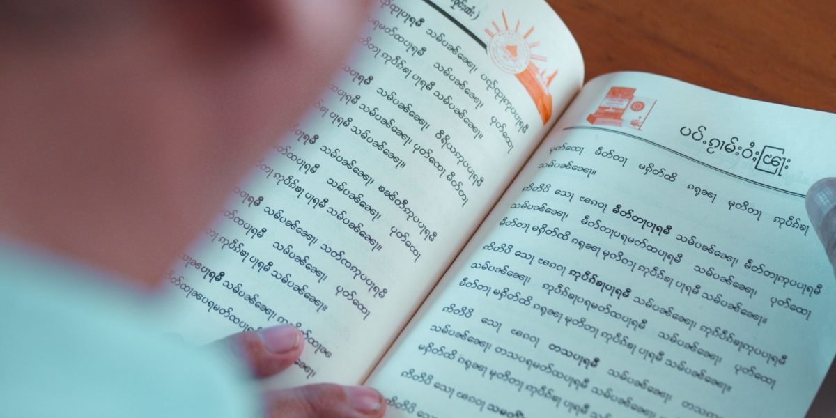 A professional concentrating intently on their learning materials, reflecting a structured approach to AI education.