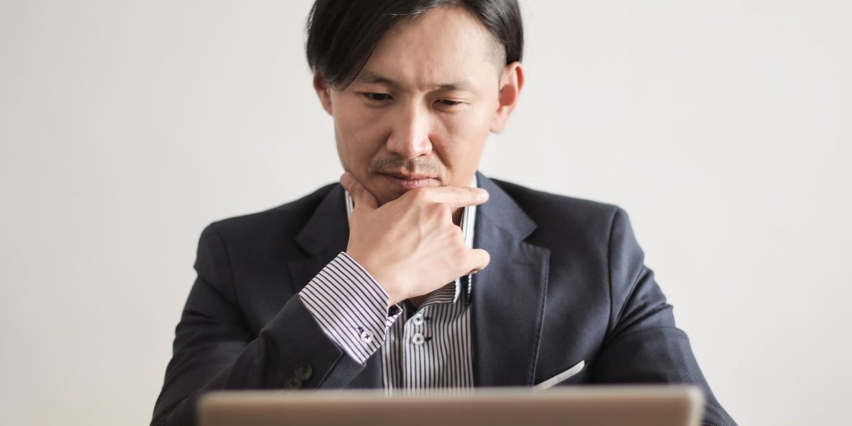 A person intently reviewing documents or notes, reflecting on important career decisions or learning paths.