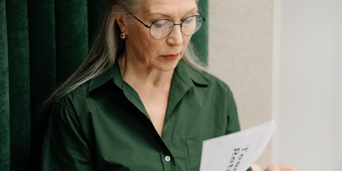 A person diligently comparing different documents, reflecting the process of evaluating and selecting the best course.