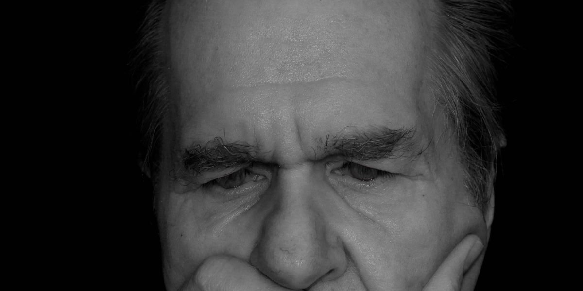 A person appears to be deep in thought, perhaps overwhelmed by complex information, reflecting the challenge of understanding fast-paced AI trends.