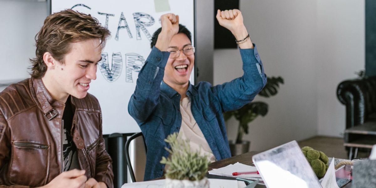 A diverse team celebrating a business achievement, perhaps after securing investment or launching a product.