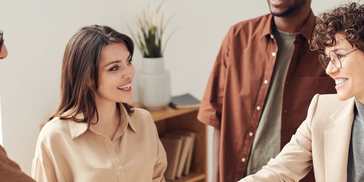 The moment of a successful professional interaction, representing networking and landing a job through effective self-promotion.