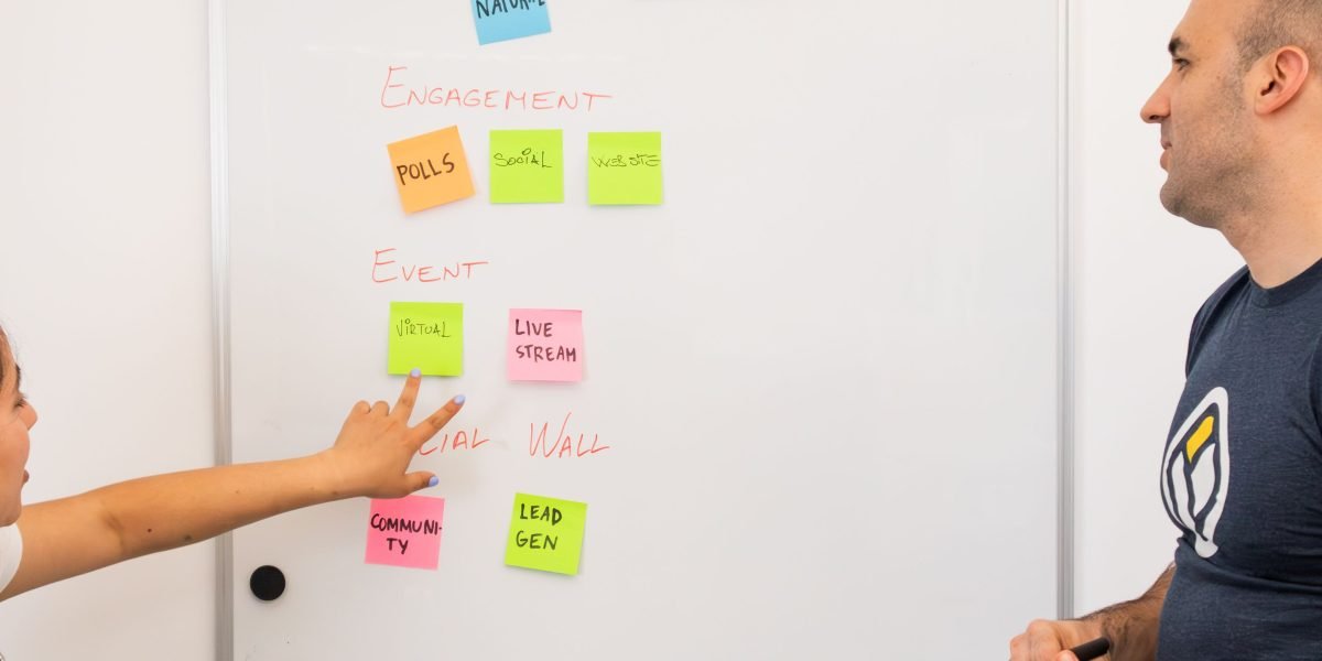 A team actively collaborating, using a whiteboard to discuss and compare different AI ethics frameworks.