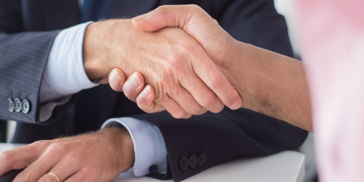 Executives concluding a meeting, symbolizing collaboration and agreement on ethical AI practices.