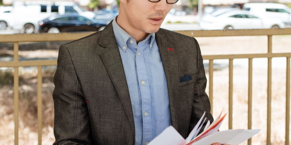 A person meticulously reviewing various documents, symbolizing the careful evaluation of AI course credentials.